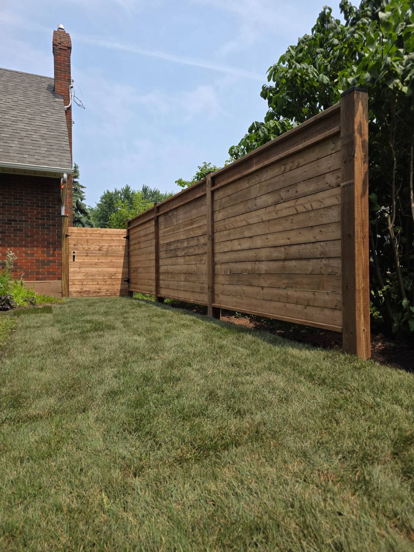 New horizontal wood privacy fence with a matching gate